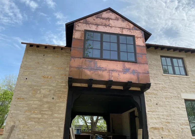 Copper metal panel facade on a stone building for Skylight Installation in Blakely